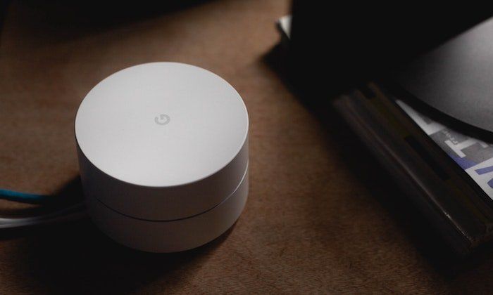 A discounted Google Wi-Fi router is seen on a table.