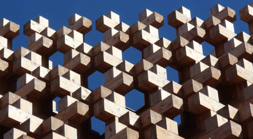 A wooden cube structure with a blue sky in the background, showcased through a captivating wordpress plugin.