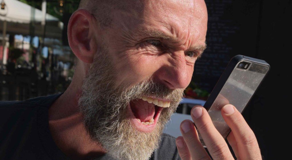A man using the wpvivid WordPress plugin is angrily yelling into his cell phone.