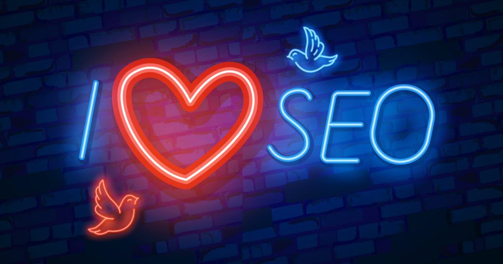 A neon sign featuring the words "i love seo" and a discount code for WPvivid and planethoster.