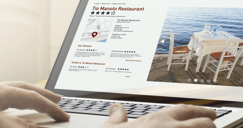 A person is using a laptop to look at a restaurant website powered by the wpvivid WordPress plugin.