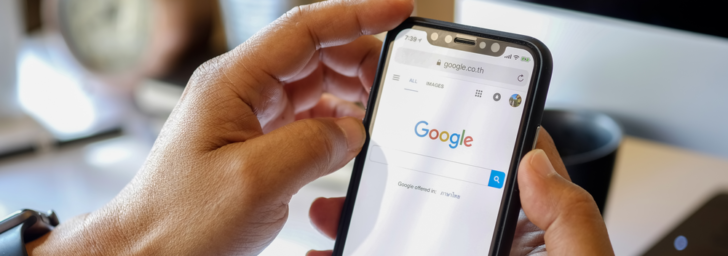 A person holding a phone with the Google logo on it while using a WordPress plugin.